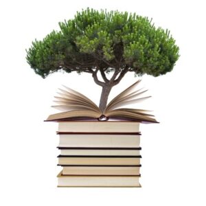 Tree growing out of books.
